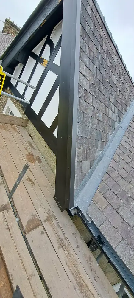 Dormer exterior with slate tiling and dark trims