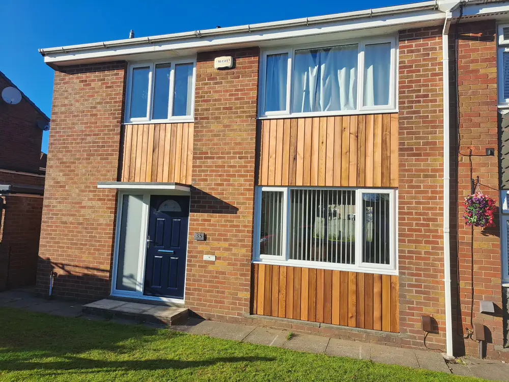 Brick house with newly fitted warm timber cladding