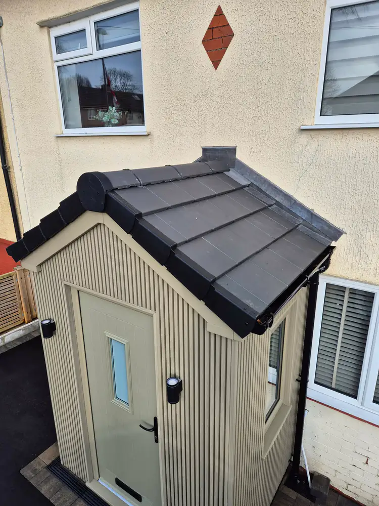 Porch extension with pale vertical cladding and a pitched tiled roof