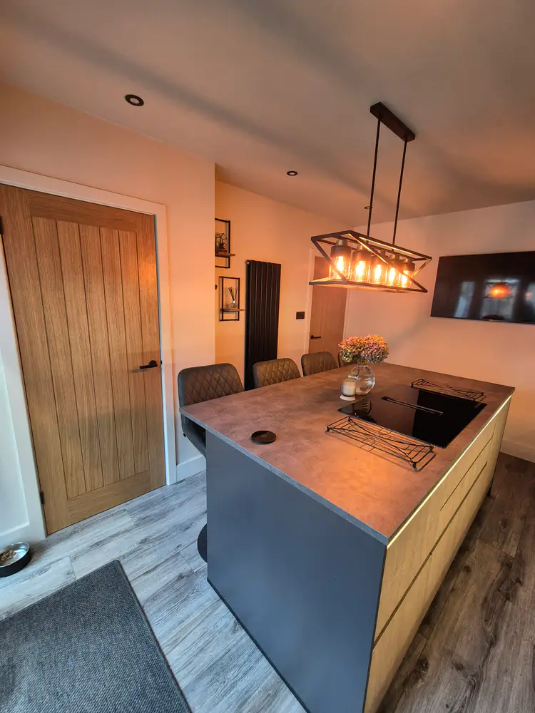 Completed kitchen and dining space with warm lighting