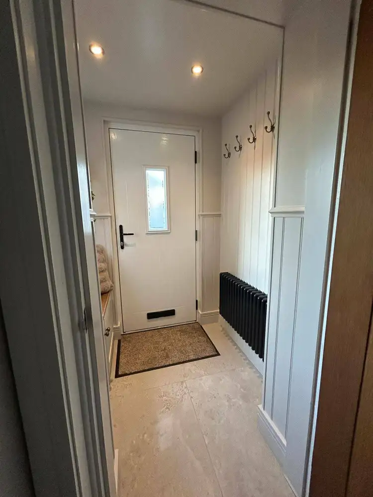 Finished property interior with pale walls and a white entrance door